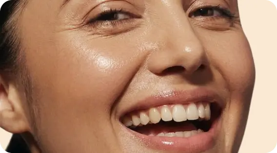 Person with clear, healthy skin smiling